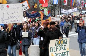 Demonstrators march down Benjamin Franklin Parkway in Philadelphia to protest planned Mayor Nutter's library closures