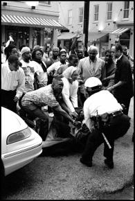 Protesters attempt to defend a fellow marcher from police during the protests in Cincinnati in 2001