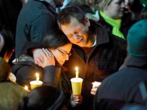 Families in Newtown mourn at a vigil for the children and teachers killed in the school shooting