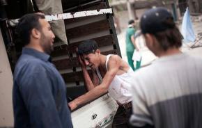 A group of Syrian men mourn the loss of a loved one