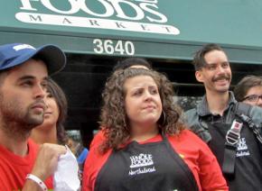 Rhiannon Broschat-Salguero (center) at a protest alongside coworkers and supporters