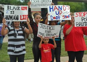 Lining the streets of Ferguson, Mo., to protest police murder