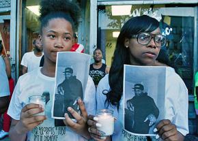 Family and friends participate in a vigil for Delrawn Small