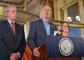 Illinois Gov. Bruce Rauner (center) holds a press conference on the state budget