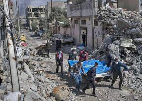 Residents pull victims from the rubble following a coalition air strike in Mosul