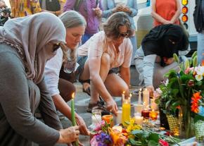 Community members mourn the victims of an Islamophobic attack in Portland