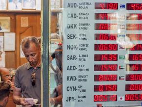 A display board shows the fall in the value of the Turkish lira at a currency exchange in Istanbul