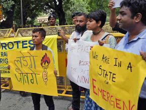 Protesters rally against a wave of police raids against human rights activists