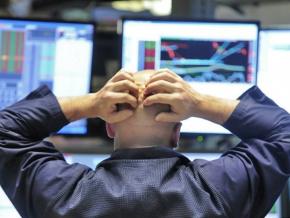 A financial trader looks on as stock prices collapse